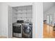 Laundry room features washer, dryer, wire shelves, and open closet space at 126 Spanish Moss Ct, Orlando, FL 32828