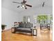 Sunlit living room featuring hardwood floors, high ceilings, and a comfortable seating area at 126 Spanish Moss Ct, Orlando, FL 32828
