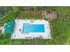 Aerial view of community pool, playground, mature trees, and amenity center, creating a resort-style atmosphere at 12868 Holdenbury Ln, Windermere, FL 34786