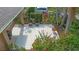 View of a spacious back patio area with lush landscaping offering privacy, and adorned with flower pots at 12868 Holdenbury Ln, Windermere, FL 34786