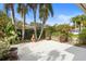 Backyard patio featuring palm trees, tropical plants, and a fire pit at 12868 Holdenbury Ln, Windermere, FL 34786