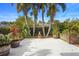 Backyard patio with palm trees and a stucco fireplace at 12868 Holdenbury Ln, Windermere, FL 34786