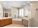 Luxurious bathroom with dual sinks, soaking tub, and glass-enclosed shower at 12868 Holdenbury Ln, Windermere, FL 34786