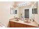 Bathroom featuring double sinks, a large mirror, and stylish vanity with generous lighting at 12868 Holdenbury Ln, Windermere, FL 34786