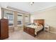 Comfortable bedroom featuring carpet and a well-lit room with three windows at 12868 Holdenbury Ln, Windermere, FL 34786