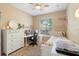 Bedroom with lots of light from a window, a desk and a single bed at 12868 Holdenbury Ln, Windermere, FL 34786