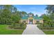 Charming yellow clubhouse with green roof, beautiful landscaping, and a glimpse of the community pool beyond at 12868 Holdenbury Ln, Windermere, FL 34786