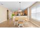 Bright dining area with a round wood table and seating for six, adjacent to the kitchen at 12868 Holdenbury Ln, Windermere, FL 34786