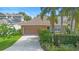 Charming home with a neutral exterior, lush landscaping, and a convenient two-car garage at 12868 Holdenbury Ln, Windermere, FL 34786