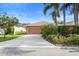Charming home with a neutral exterior, lush landscaping, and a convenient two-car garage at 12868 Holdenbury Ln, Windermere, FL 34786