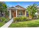 Beautiful home with a quaint front porch, well-maintained lawn, and lush landscaping at 12868 Holdenbury Ln, Windermere, FL 34786