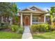 Attractive home with manicured lawn, walkway, colorful garden and welcoming front porch with pillars at 12868 Holdenbury Ln, Windermere, FL 34786