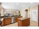 Open concept kitchen with stainless steel appliances, center island, and breakfast bar seating at 12868 Holdenbury Ln, Windermere, FL 34786