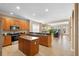 Modern kitchen featuring wood cabinetry, stainless appliances, a center island, and an open layout at 12868 Holdenbury Ln, Windermere, FL 34786