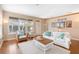 Bright living room with a decorative beach theme, hardwood floors, large windows, and white couch at 12868 Holdenbury Ln, Windermere, FL 34786