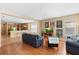Inviting living room featuring hardwood floors, a comfortable blue sofa, and nostalgic movie poster decor at 12868 Holdenbury Ln, Windermere, FL 34786