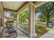 Inviting front porch with rocking chairs and decorative columns at 12868 Holdenbury Ln, Windermere, FL 34786