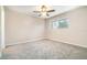 Carpeted bedroom featuring a ceiling fan, a window, and ample space for furnishings at 1301 Winter Green Way, Winter Garden, FL 34787