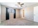 Light-filled bedroom featuring plush carpeting, ceiling fan, closet, and a window with dark curtains at 1301 Winter Green Way, Winter Garden, FL 34787