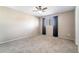 Neutral bedroom with a carpeted floor, ceiling fan, window with curtains, and white trim at 1301 Winter Green Way, Winter Garden, FL 34787