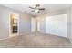 Bedroom featuring neutral carpet, a ceiling fan, and access to a private ensuite bathroom at 1301 Winter Green Way, Winter Garden, FL 34787