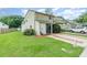 Charming townhome with a green tile roof, lush front yard, and brick-lined driveway at 1301 Winter Green Way, Winter Garden, FL 34787