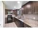 Modern kitchen with stainless steel appliances and granite countertops at 1301 Winter Green Way, Winter Garden, FL 34787