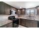 Modern kitchen with stainless steel appliances and granite countertops at 1301 Winter Green Way, Winter Garden, FL 34787