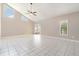 Open-concept living area with tile floors, high ceilings, and natural light from windows and sliding glass door at 1301 Winter Green Way, Winter Garden, FL 34787