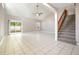 Spacious living room with vaulted ceilings, tiled floors, and natural light from the sliding glass door at 1301 Winter Green Way, Winter Garden, FL 34787
