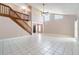 Open living room featuring high ceilings, staircase with wooden railing, and sliding doors to the outdoors at 1301 Winter Green Way, Winter Garden, FL 34787