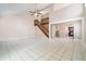 Bright and airy living room with tile flooring, open layout, staircase, and access to the kitchen at 1301 Winter Green Way, Winter Garden, FL 34787