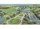 Aerial image capturing a community golf course with lakes and meticulously landscaped streets at 14088 Tarvin St, Orlando, FL 32832