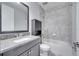 Bathroom with gray tile, granite vanity, and shower-tub combo at 14088 Tarvin St, Orlando, FL 32832
