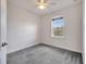 Bright bedroom featuring neutral walls, gray carpet, and arched window at 14088 Tarvin St, Orlando, FL 32832