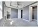 Gray bedroom with neutral carpet, ceiling fan, doorway to bathroom and walk-in closet at 14088 Tarvin St, Orlando, FL 32832