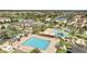 Aerial view showcasing the community pool area with palm trees and various amenities at 14088 Tarvin St, Orlando, FL 32832