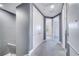 Hallway with gray carpet, white trim, and doors leading to different rooms at 14088 Tarvin St, Orlando, FL 32832