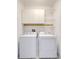 Laundry room featuring washer, dryer, storage cabinets, and shelving at 14088 Tarvin St, Orlando, FL 32832