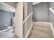 Carpeted staircase leads to a bathroom, complete with white banister at 14088 Tarvin St, Orlando, FL 32832