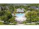 Aerial view of a community pool with lounge chairs and umbrellas surrounded by trees at 14242 Desert Haven St # Ge, Windermere, FL 34786