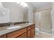 Bathroom with double sink vanity, granite counters, and a glass-enclosed shower at 14242 Desert Haven St # Ge, Windermere, FL 34786