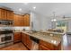 Open kitchen with granite countertops, stainless steel appliances, and breakfast bar at 14242 Desert Haven St # Ge, Windermere, FL 34786