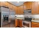 Kitchen boasts stainless appliances, granite counters and wood cabinets at 14242 Desert Haven St # Ge, Windermere, FL 34786
