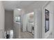 Hallway view of a laundry room with a stackable washer and dryer located in an open closet at 14242 Desert Haven St # Ge, Windermere, FL 34786