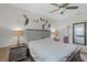 Comfortable main bedroom featuring a ceiling fan, a wooden headboard and two side tables with lamps at 14242 Desert Haven St # Ge, Windermere, FL 34786