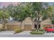 Inviting townhome exterior showcasing a well-manicured lawn and a charming two-car garage at 14242 Desert Haven St # Ge, Windermere, FL 34786