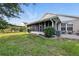 Screened-in back porch and view of the backyard from the yard at 1430 Challenger Ave, Davenport, FL 33897