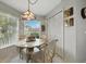 Cozy eat-in breakfast nook featuring an updated table set and a charming chandelier at 1430 Challenger Ave, Davenport, FL 33897