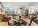 Open-plan dining area with large glass table, decorative plants, and views of the main living area at 1430 Challenger Ave, Davenport, FL 33897